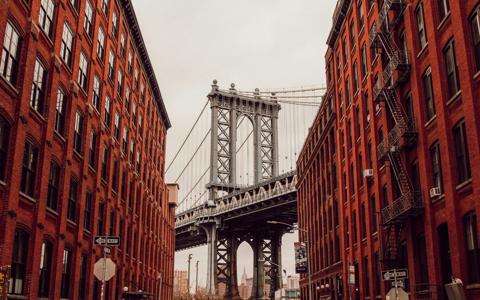 The Manhattan Bridge framed by red-brick buildings in DUMBO, Brooklyn